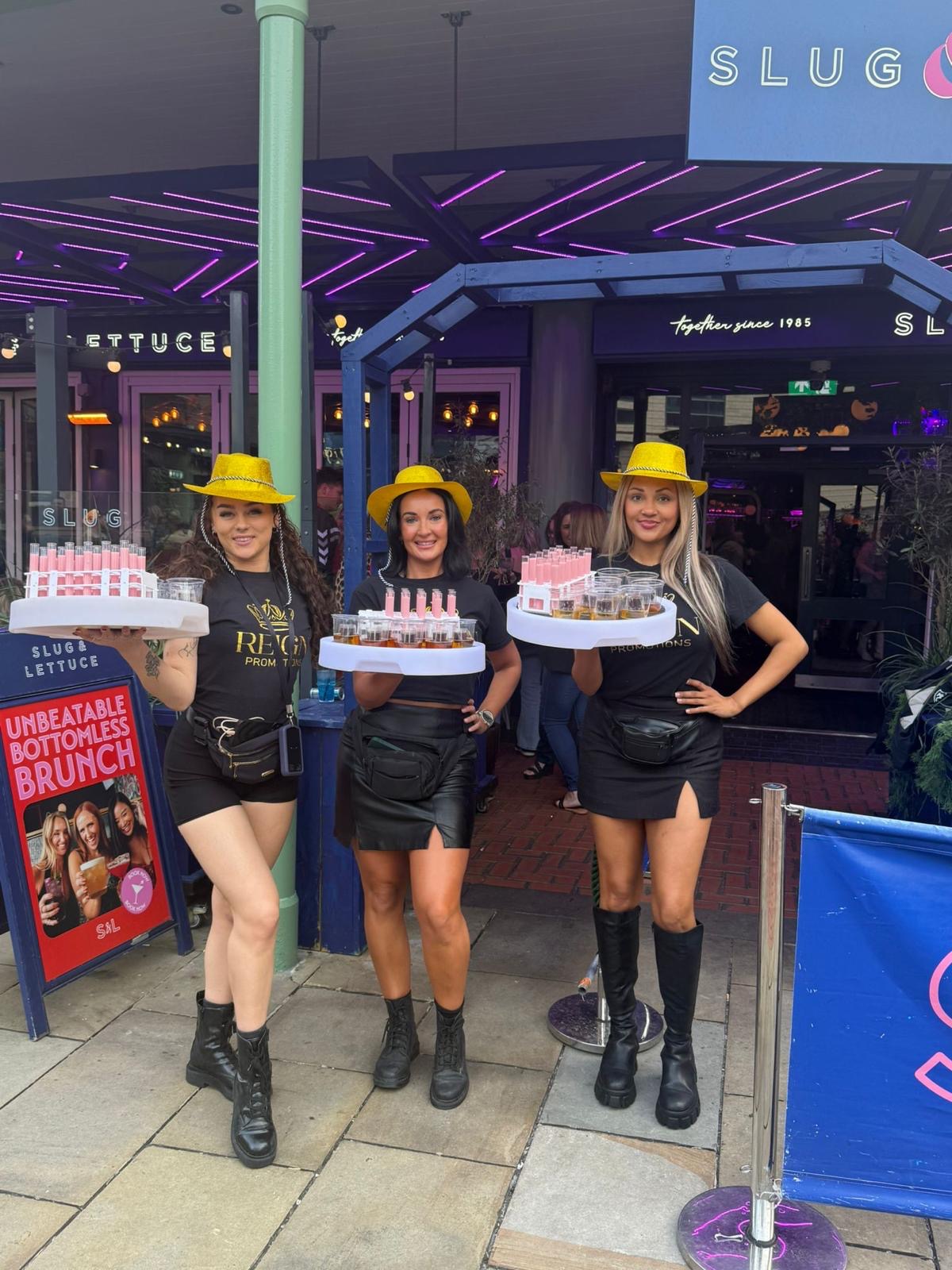 Reign hostesses with shot trays outside Slug & Lettuce